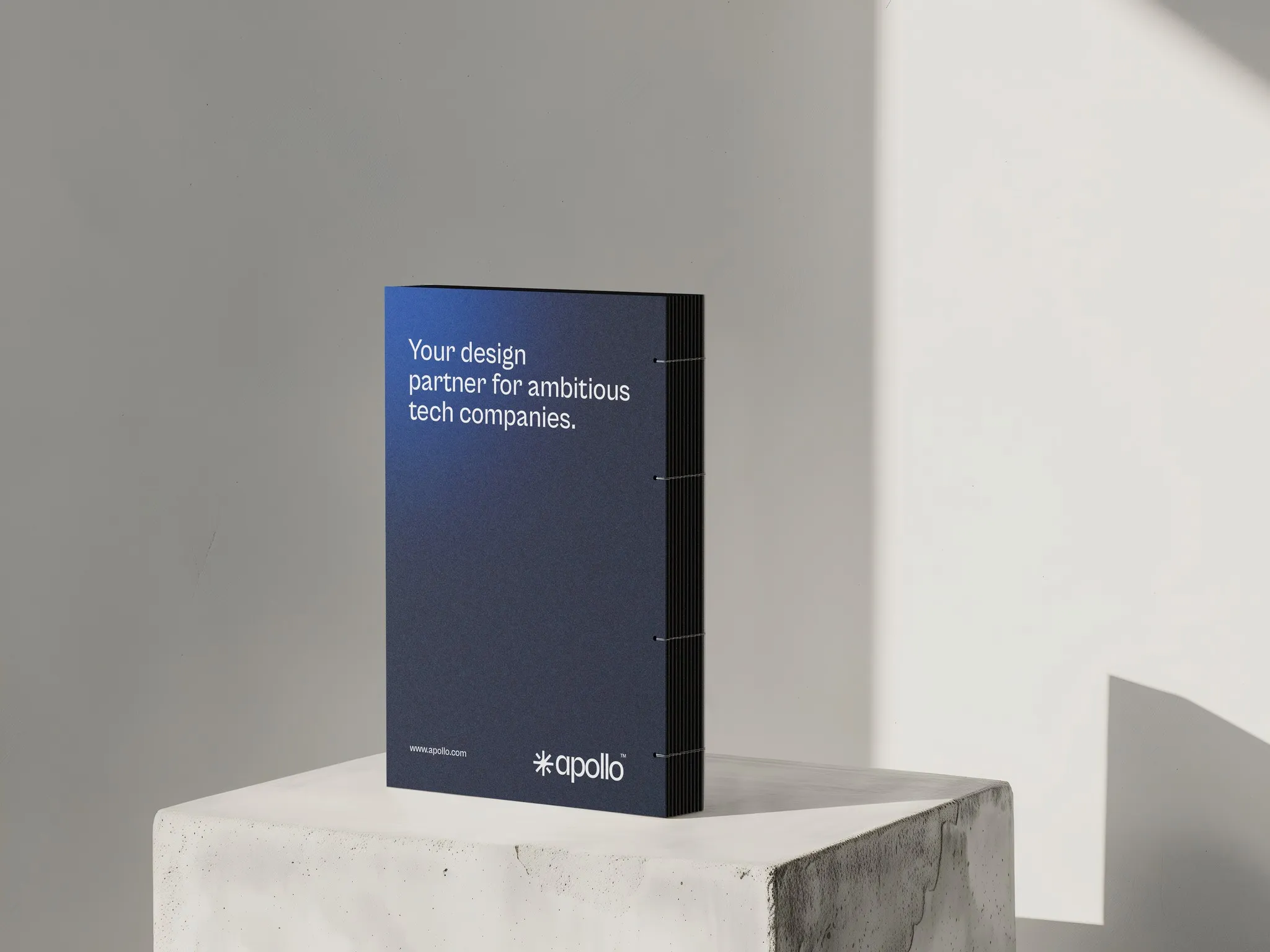 Apollo Studio brand guidelines book on a plinth