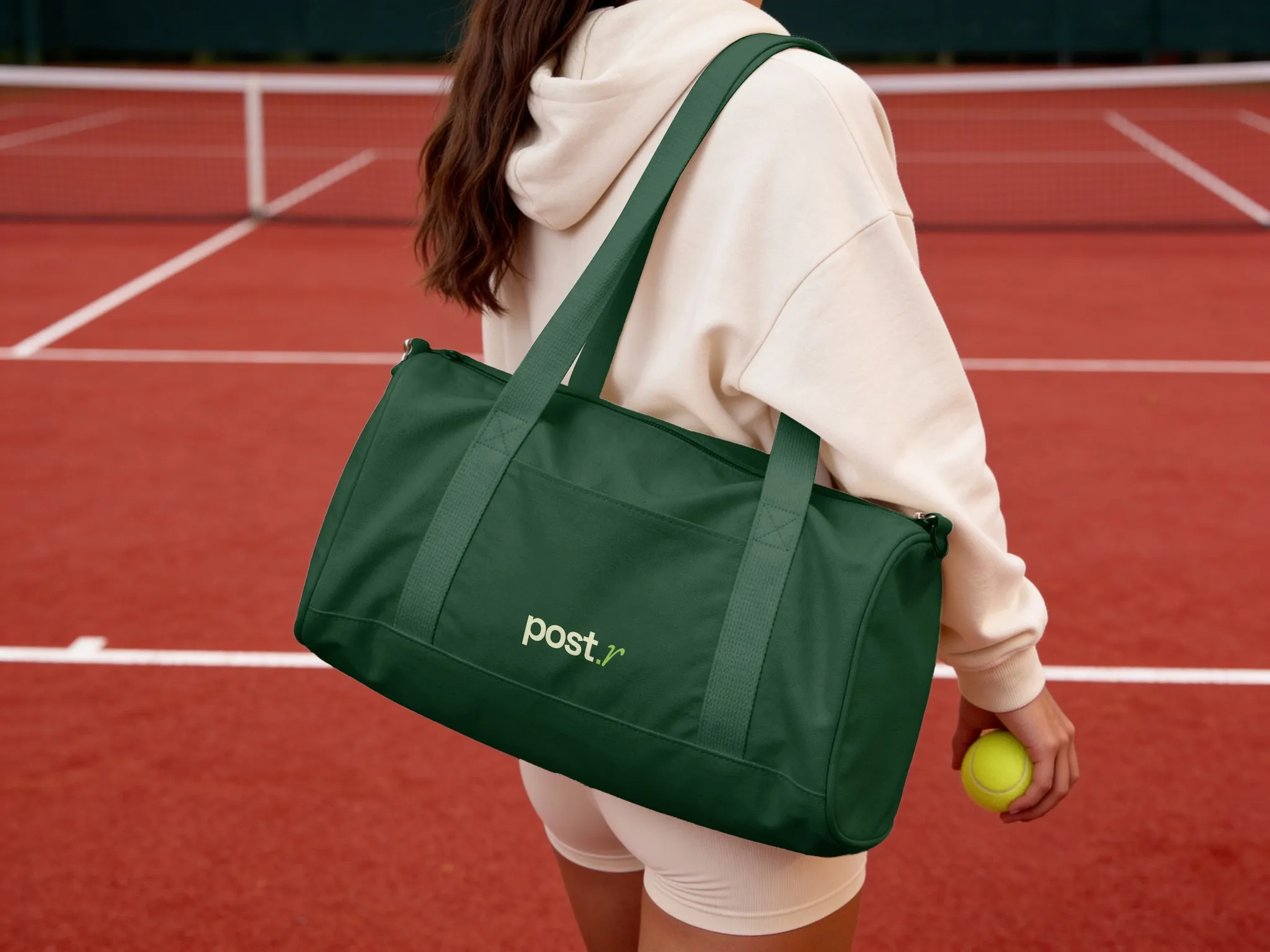 Green post.r gym bag on a clay court