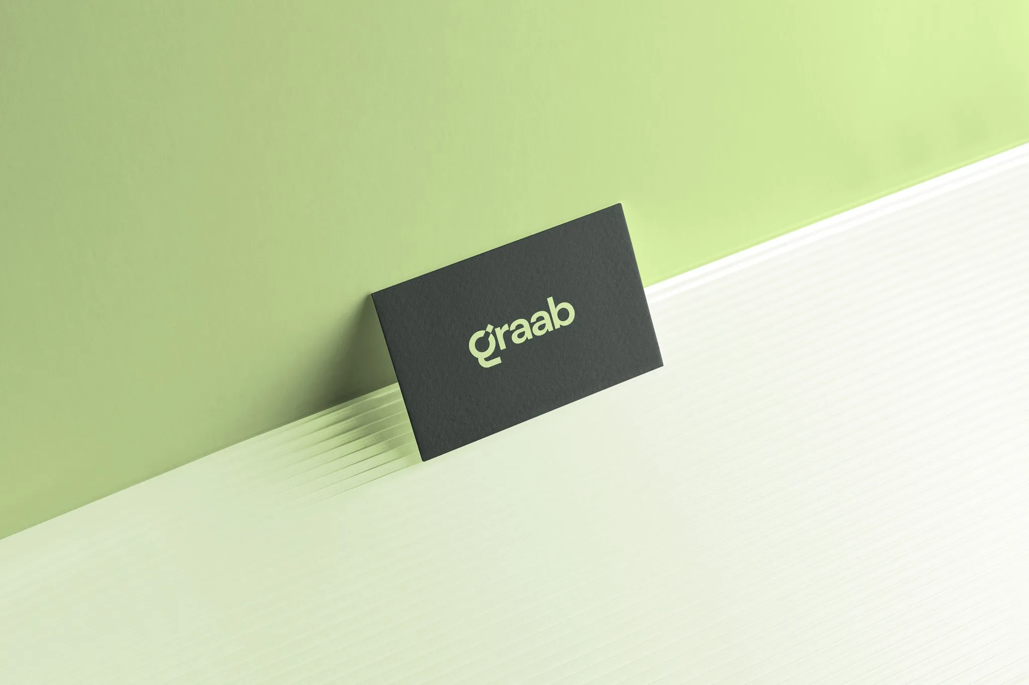 Graab business card on a light green surface
