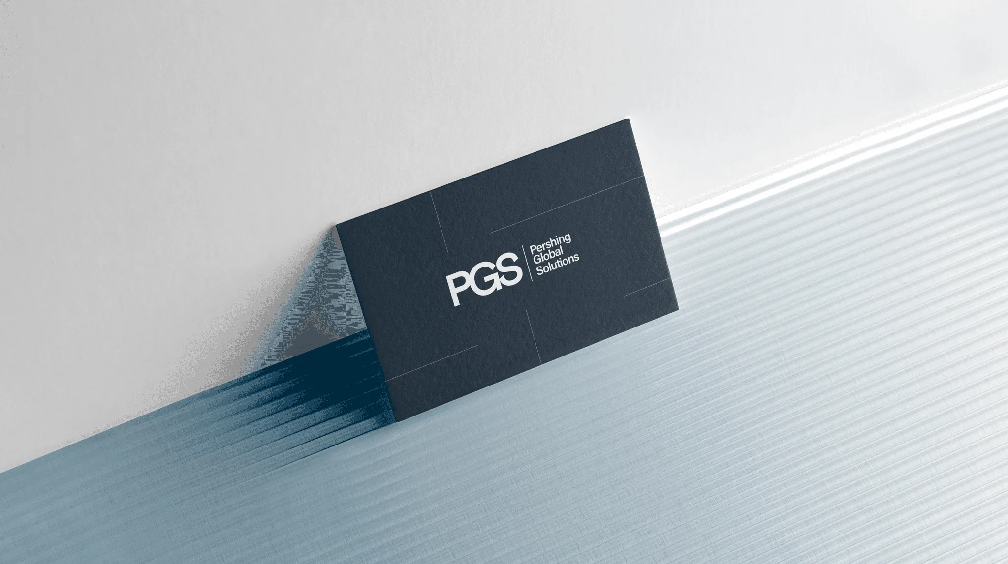 PGS business card on a light surface