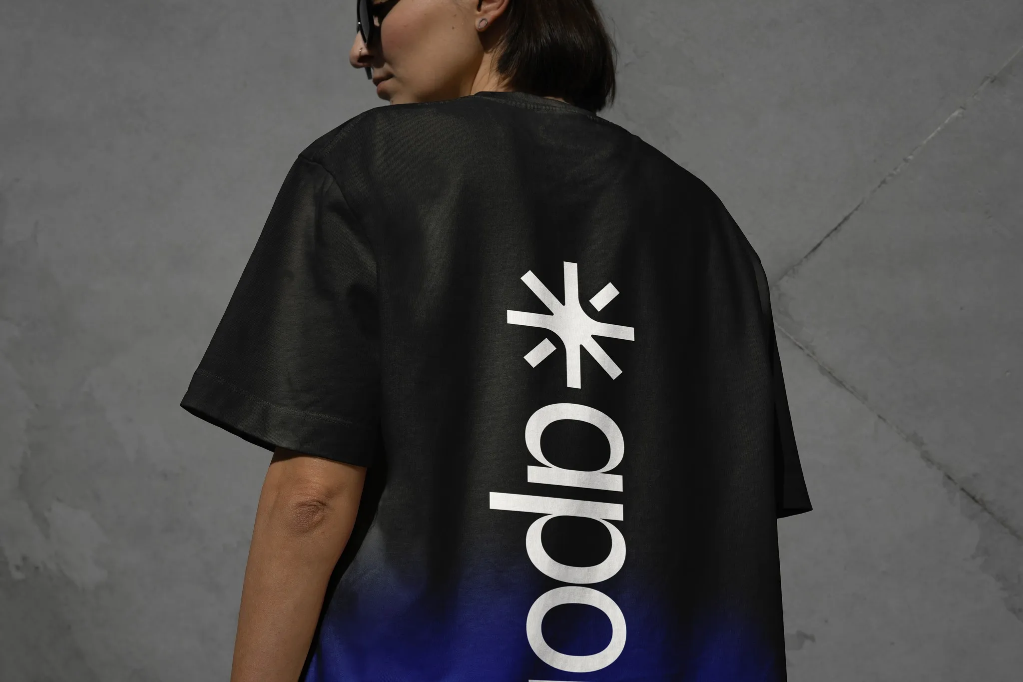 Person wearing a black Apollo Studio T-shirt with the Apollo logo